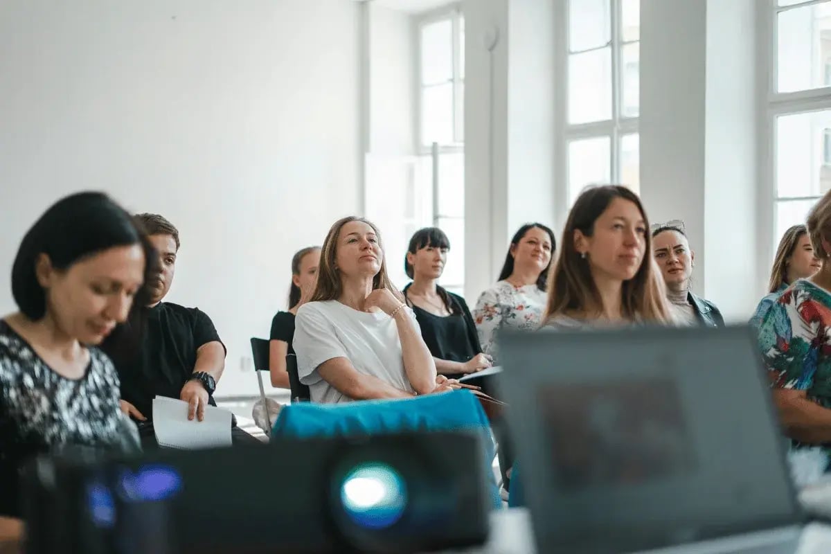 Audience listening attentively at a professional workshop.