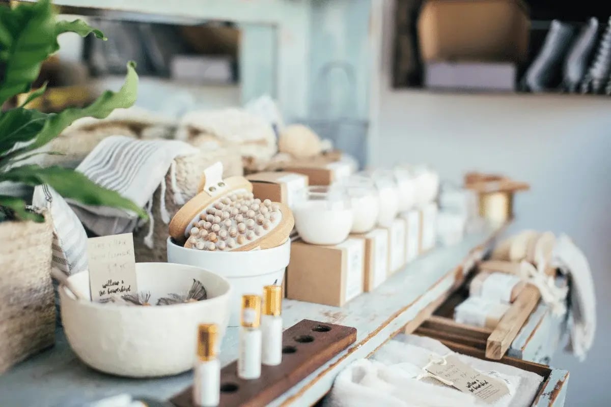 Holistic spa items like body oils, cleansers, and towels in a cozy setting.