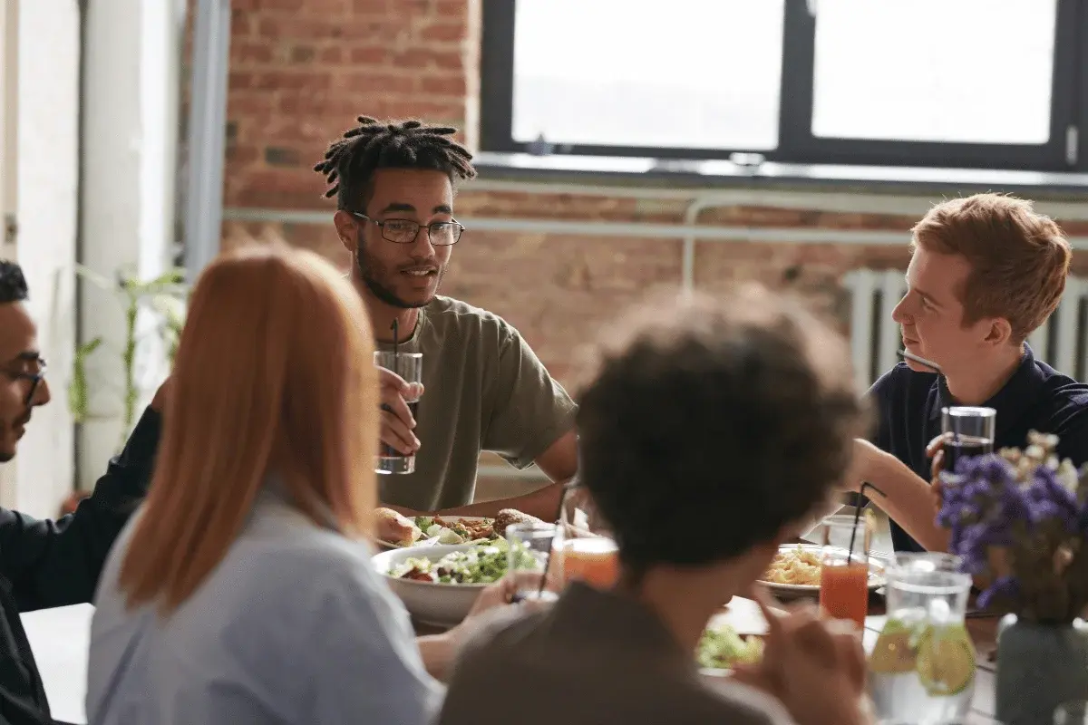 Group of friends enjoying a casual lunch together around a table.