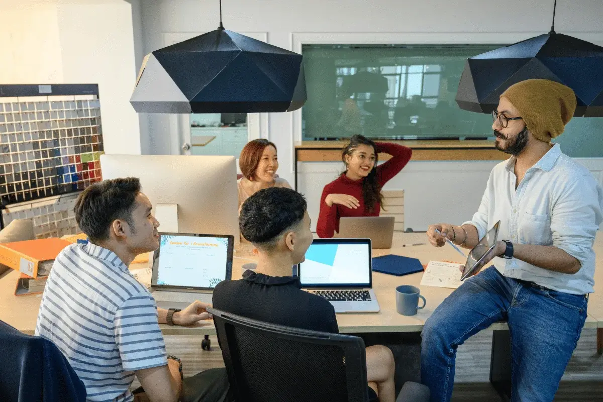 Team brainstorming ideas together in a creative workspace.