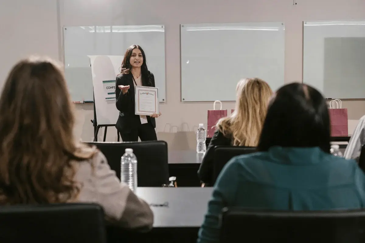 Woman presenting a certificate during business seminar.